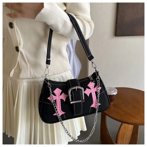 Detail of black canvas underarm bag featuring pink crosses and silver metal buckle