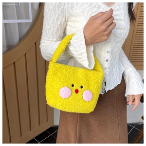 Detail view of mini yellow plush tote bag with cute cartoon chick face in soft fleece