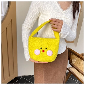 Detail of yellow plush cartoon tote bag with cute facial features and fluffy texture