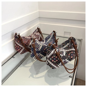 Detailed view of bohemian geometric woven handbags in three diverse color patterns