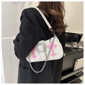 White canvas shoulder bag with pink cross embroidery and silver chain shown on model