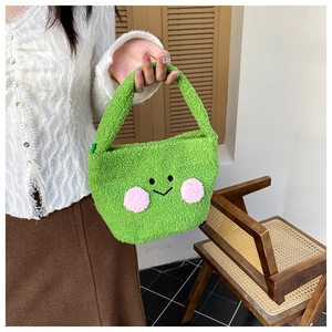 Close-up of green plush mini handbag with cute smiley face and soft faux fur texture