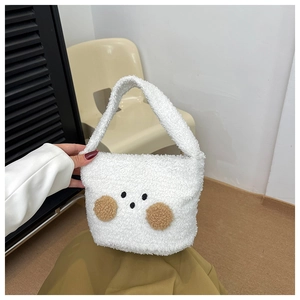 Detailed close-up of soft plush teddy bear bag showing cute facial features and fuzzy texture
