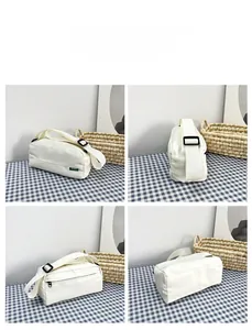 Detailed views of the white nylon pillow bag showing side, front, zipper and base