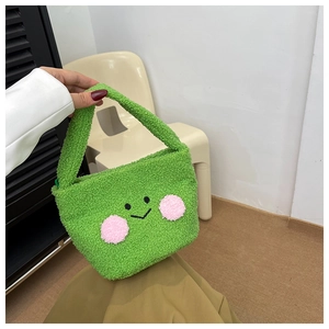 Detail of green teddy plush mini bag featuring a cute cartoon face and soft fleece texture