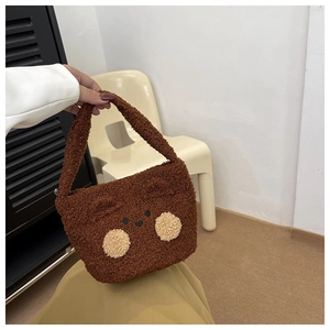 Detail of soft plush brown bear shoulder bag with cute embroidered facial features