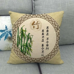 Detail of linen pillowcase featuring green bamboo print and Chinese calligraphy on a grey sofa