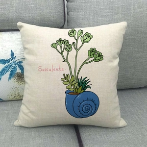 Close-up of linen pillow cover with snail shell succulent pot print on a grey sofa