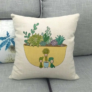 Detail of linen cushion cover showing cactus cartoon print and woven fabric texture