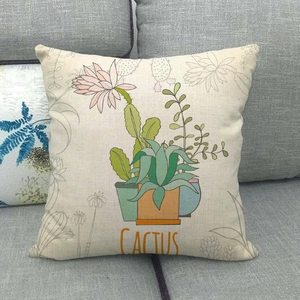 Detailed close-up of cactus pattern on linen pillowcase against a gray sofa backdrop