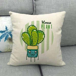 Detailed texture of linen pillowcase with green cartoon cactus on grey sofa