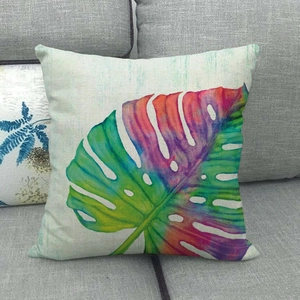 Square linen pillowcase with colorful gradient monstera leaf pattern on sofa