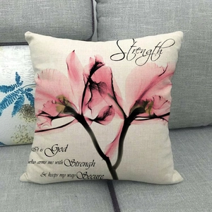 Detailed texture of square beige linen pillowcase with pink floral art and Strength text