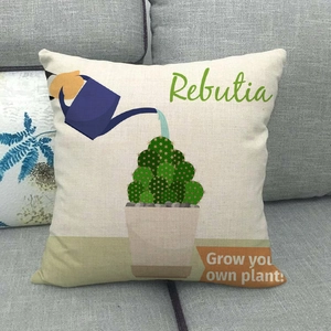 Linen pillowcase detail featuring cactus print and blue watering can on a gray sofa