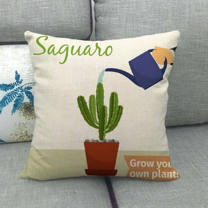 Macro detail of linen cactus pillowcase with Saguaro artwork on a gray sofa