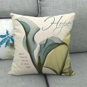 Detail of linen pillowcase with X-ray flower print and Hope text on a gray sofa