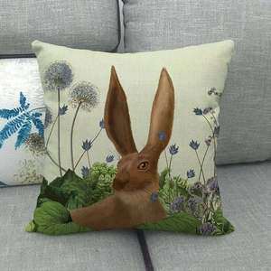 Detailed texture of linen cushion cover featuring a vintage rabbit and floral print