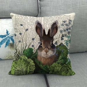 Detailed close-up of linen pillow cover featuring vintage rabbit and botanical leaf print