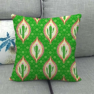 Detail of green cactus print linen pillowcase showing fabric texture on a grey sofa