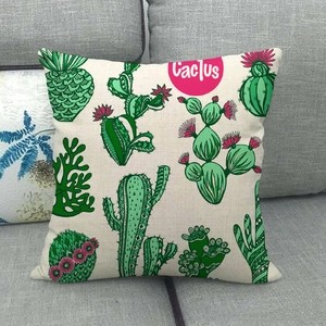 Detailed texture of linen cushion cover featuring hand-drawn cactus plants on a grey sofa