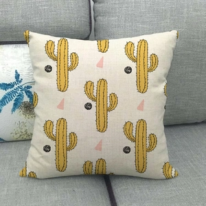Detailed texture of linen pillowcase with yellow cactus and black dot geometric pattern