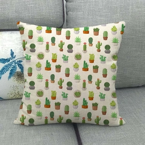 Close-up of linen cactus pillowcase texture on a grey sofa with illustrative green plants