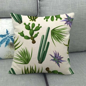 Linen cactus throw pillow cover with tropical green plants on a grey sofa