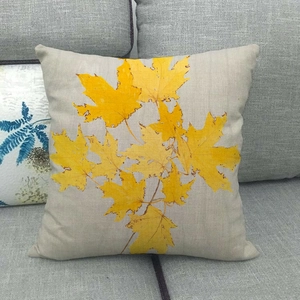 Detailed texture of cotton linen pillowcase with vibrant yellow maple leaf print