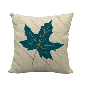 Linen pillowcase with blue maple leaf print and golden veins on light wood texture
