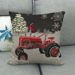 Linen Christmas pillow cover with vintage red tractor and snowy tree on grey sofa