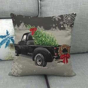 Detail of vintage Christmas truck print on linen pillowcase with snowflake patterns