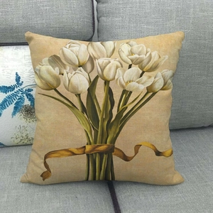 Detail of colorful floral linen pillowcase showing tulip print and woven fabric texture