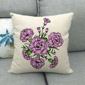 Detailed close-up of colorful floral bouquet linen pillowcase on a grey fabric sofa