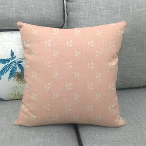 Detailed texture of pink geometric leaf pattern on square cotton linen pillowcase
