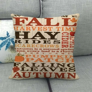 Square linen autumn pillow cover with Fall letters and pumpkin design on a grey sofa