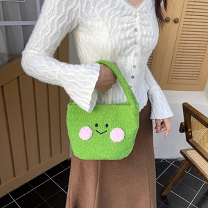 Cute green teddy fleece shoulder bag featuring an embroidered smiley face on a model