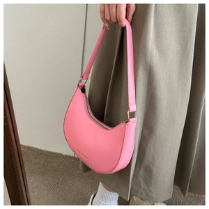 Detail of pink half-moon shoulder bag with FASHION & BAGS text and golden buckles