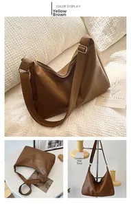 Detail view of large yellow-brown PU leather tote bag with soft texture and adjustable strap