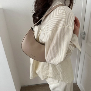 Minimalist beige hobo shoulder bag with a sleek crescent design for women