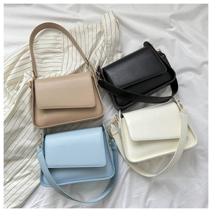 Flat lay of vintage square shoulder bags in khaki, black, blue, and off-white colors