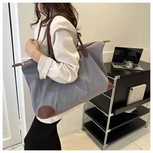 Bolso tote de nailon gris de gran capacidad en un entorno de oficina para el trabajo