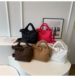 Quilted nylon tote bag featuring a bow decoration and diverse autumn color options