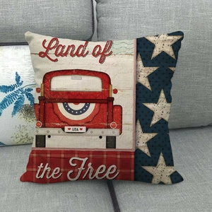 Detail of American vintage red truck linen pillow cover on a grey sofa