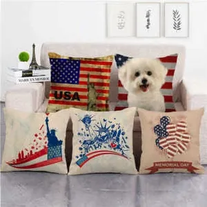 Detail view of American flag and Statue of Liberty linen pillow covers on a beige sofa