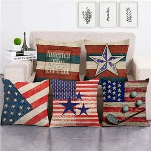 Detailed set of five vintage American flag linen pillow covers on a cozy sofa