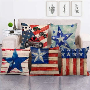 Detail view of 5-piece American flag linen pillow covers on a cozy living room sofa