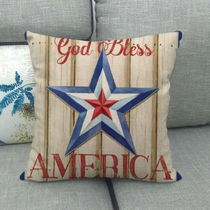 Macro shot of God Bless America linen pillowcase on a grey sofa with star print