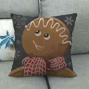 Detail shot of linen Christmas pillowcase featuring a cute gingerbread man and snowflakes