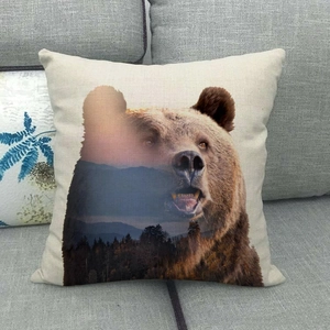 Detailed close-up of a rustic bear and forest landscape print on a linen throw pillowcase