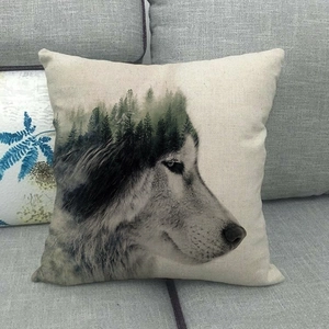 Detailed close-up of a wolf and forest print on a square beige linen pillow case